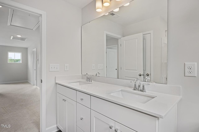 bathroom featuring double vanity, visible vents, and a sink