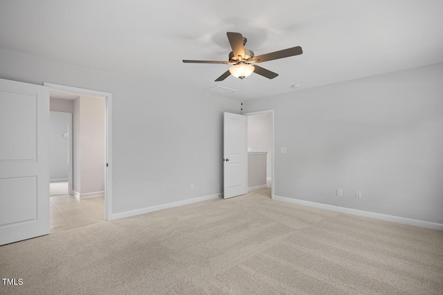 unfurnished bedroom featuring light colored carpet, ceiling fan, visible vents, and baseboards