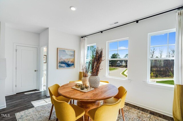414 Rowe Way, Knightdale, NC 27545 - dining space featuring a wealth of natural light, visible vents, and wood finished floors