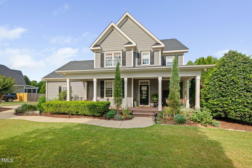 4769 Swordfish Dr, Raleigh, NC 27603 - view of front of home featuring a front yard, a porch, and roof with shingles