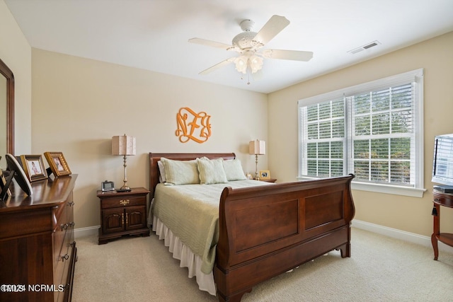 bedroom featuring light colored carpet, visible vents, ceiling fan, and baseboards