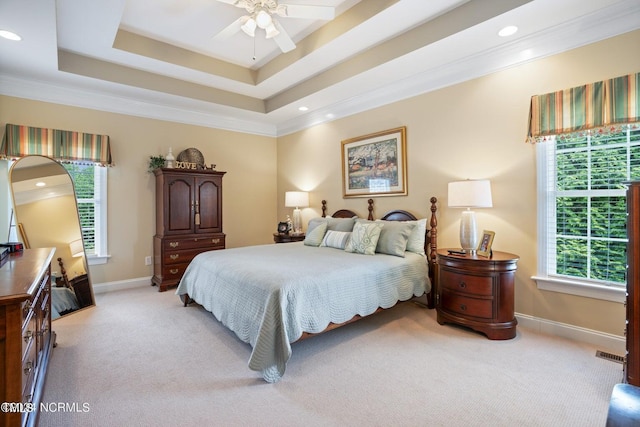 bedroom featuring a raised ceiling, baseboards, light colored carpet, and visible vents
