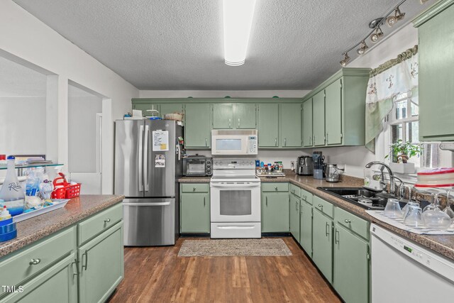 kitchen with a sink, a textured ceiling, dark wood-style flooring, white appliances, and a toaster