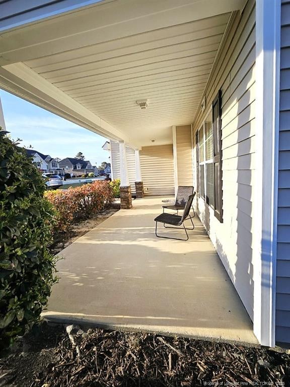 view of patio / terrace with covered porch and a residential view