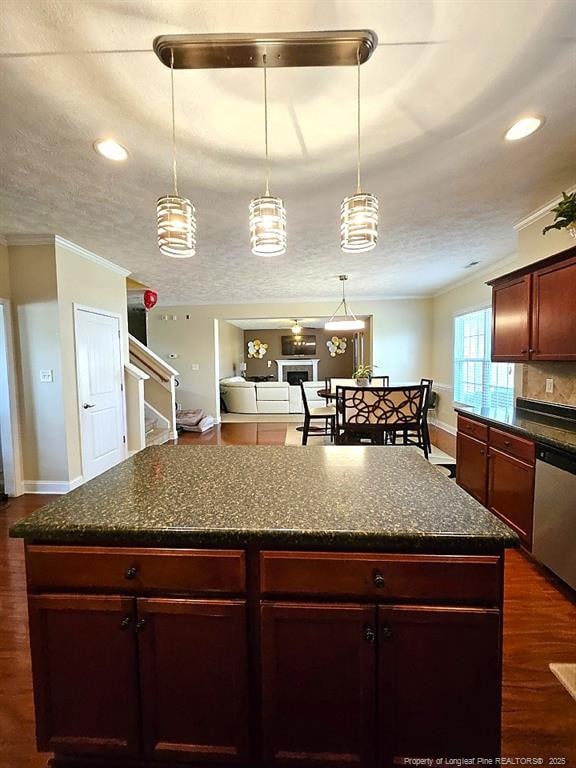 kitchen featuring baseboards, stainless steel dishwasher, and dark wood finished floors