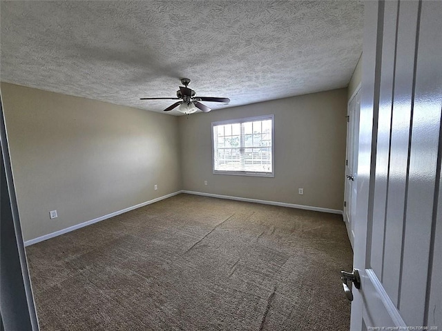 carpeted empty room featuring a ceiling fan, a textured ceiling, and baseboards