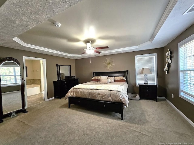 bedroom featuring baseboards, carpet, a raised ceiling, and ceiling fan