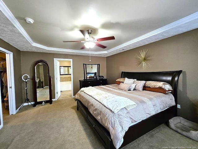 bedroom with crown molding, a raised ceiling, and light colored carpet