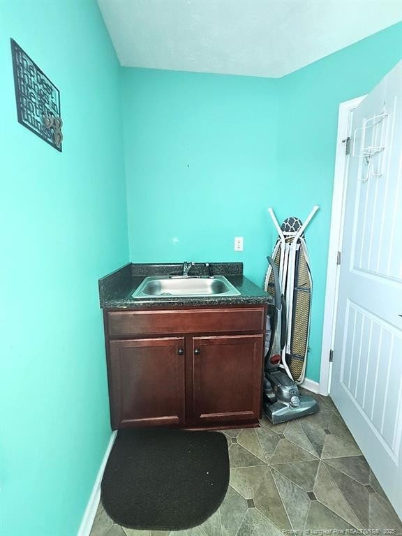 bathroom featuring baseboards and vanity