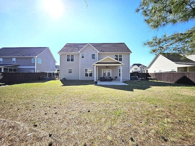 back of house with a yard, ceiling fan, a fenced backyard, and a patio area