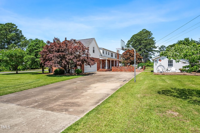 504 W Brocklyn St, Benson, NC 27504 - view of front facade with brick siding, an attached garage, driveway, and a front lawn