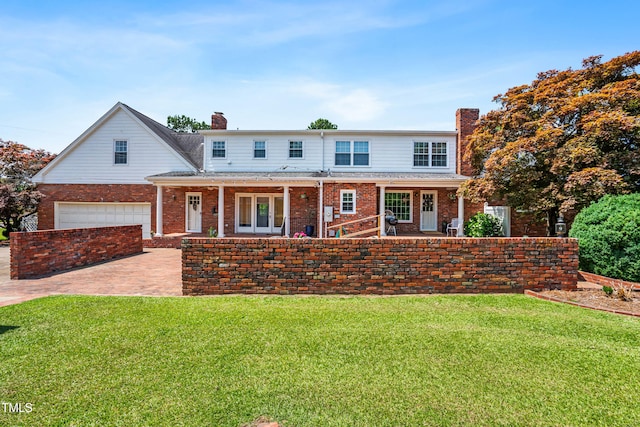 504 W Brocklyn St, Benson, NC 27504 - view of front facade featuring a chimney, brick siding, and a front lawn