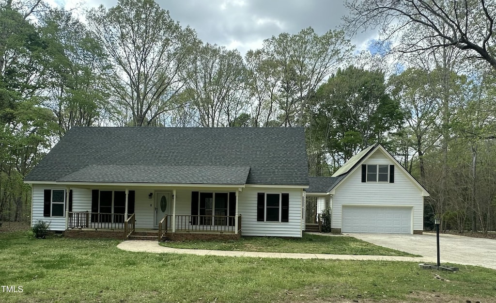 2820 Mattlyn Ct, Raleigh, NC 27613 - view of front of property featuring concrete driveway, roof with shingles, a front yard, a porch, and a garage