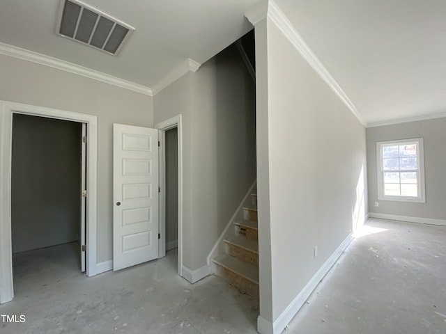 stairs with visible vents, ornamental molding, and baseboards