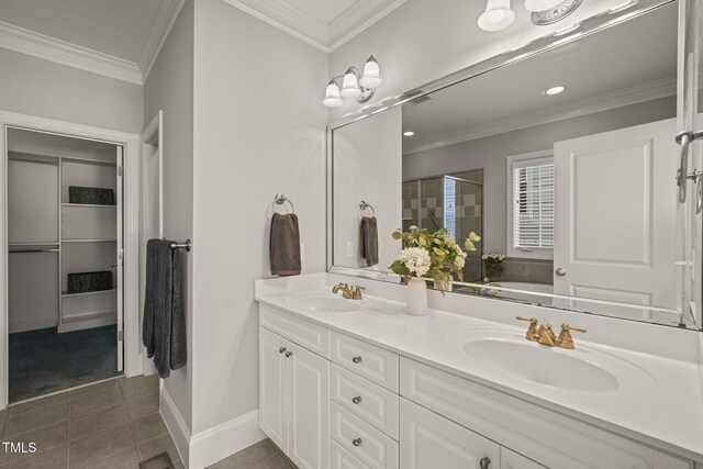 bathroom featuring double vanity, a shower stall, tile patterned flooring, ornamental molding, and recessed lighting