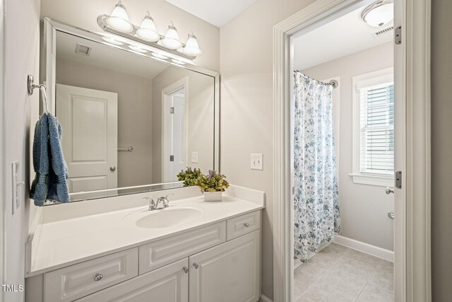 bathroom featuring tile patterned flooring, vanity, baseboards, and a shower with shower curtain