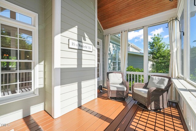 sunroom featuring plenty of natural light and lofted ceiling
