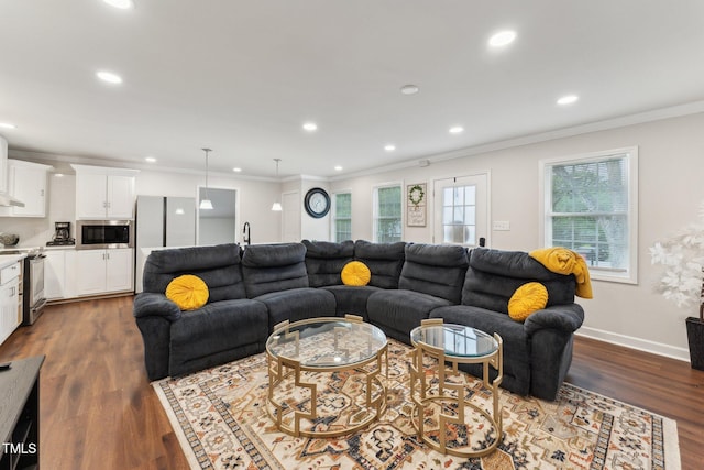 living room with ornamental molding, recessed lighting, and dark wood finished floors