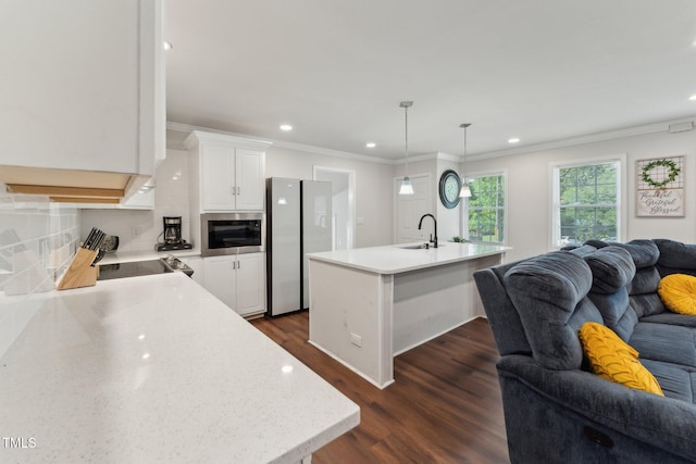 kitchen featuring recessed lighting, open floor plan, light countertops, freestanding refrigerator, and dark wood finished floors