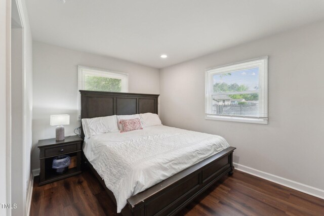 bedroom featuring dark wood-style flooring, baseboards, multiple windows, and recessed lighting