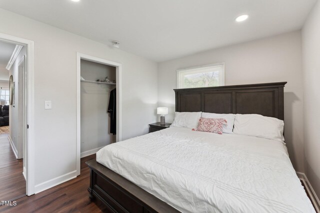 bedroom featuring a closet, recessed lighting, dark wood-style flooring, and baseboards