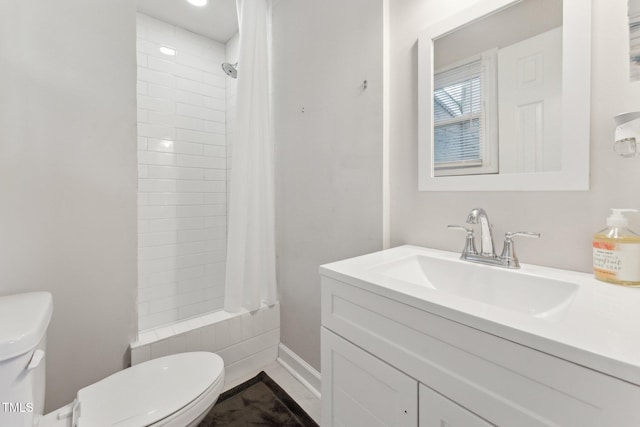 bathroom with tiled shower / bath combo, toilet, and vanity