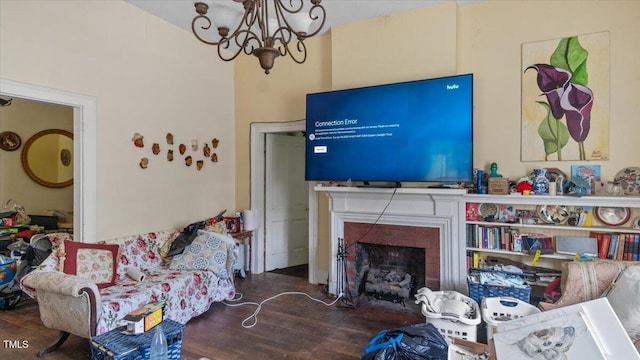 410 Halifax St, Warrenton, NC 27589 - living room with wood finished floors, a notable chandelier, and a brick fireplace