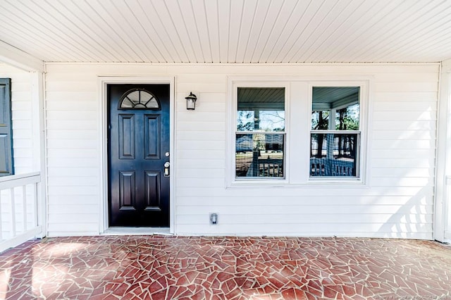 view of exterior entry with covered porch