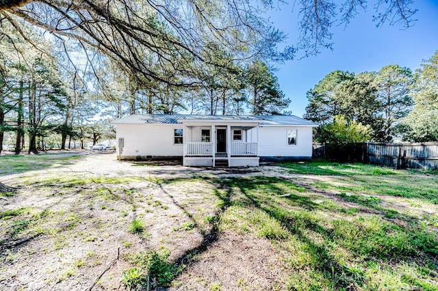 view of front of home featuring crawl space, fence, and metal roof