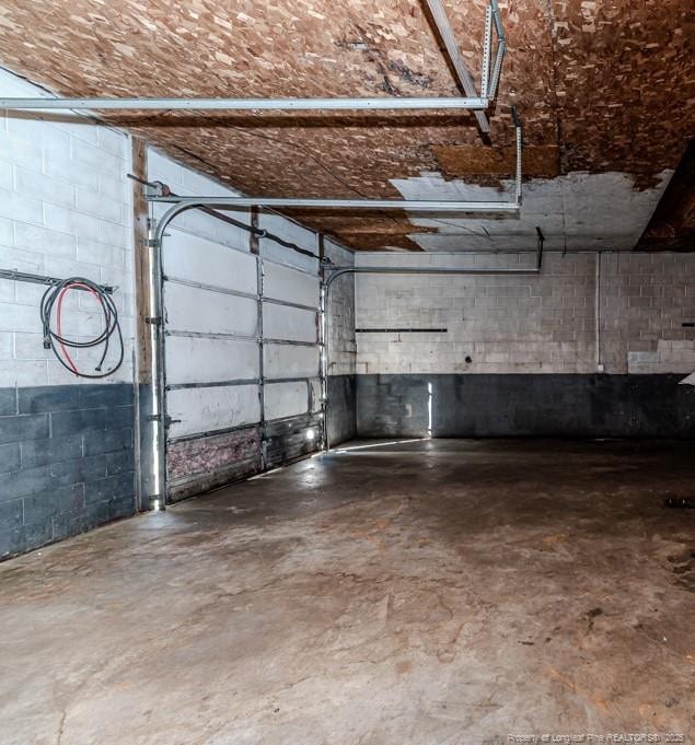 garage with concrete block wall