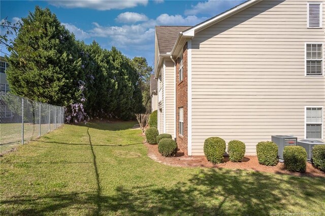 3159 Wisteria Ln Unit 101, Fayetteville, NC 28314 - view of home's exterior with cooling unit, a yard, and fence
