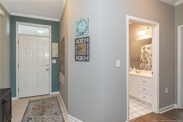 3159 Wisteria Ln Unit 101, Fayetteville, NC 28314 - foyer featuring light tile patterned flooring, baseboards, and ornamental molding