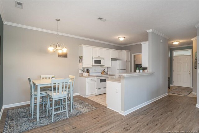 3159 Wisteria Ln Unit 101, Fayetteville, NC 28314 - kitchen featuring visible vents, light wood-style floors, and white appliances