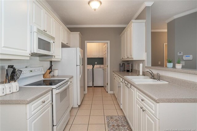 3159 Wisteria Ln Unit 101, Fayetteville, NC 28314 - kitchen with white appliances, light tile patterned floors, ornamental molding, washing machine and clothes dryer, and a sink