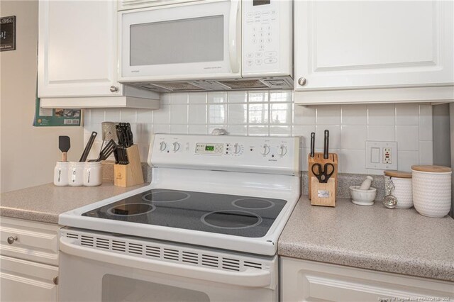 3159 Wisteria Ln Unit 101, Fayetteville, NC 28314 - kitchen with white cabinetry, light countertops, tasteful backsplash, and white appliances