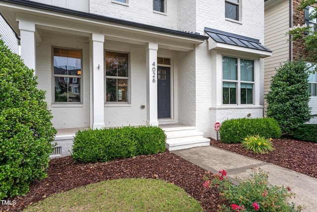 4026 Overcup Oak Ln, Cary, NC 27519 - property entrance featuring brick siding, a standing seam roof, and metal roof