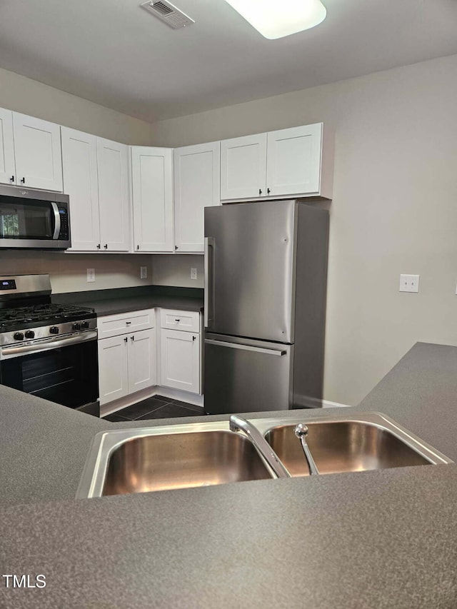 4425 Moss Garden Path, Raleigh, NC 27616 - kitchen with stainless steel appliances and white cabinets