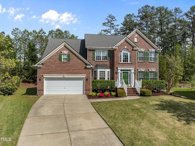 colonial house with concrete driveway, a front lawn, and brick siding