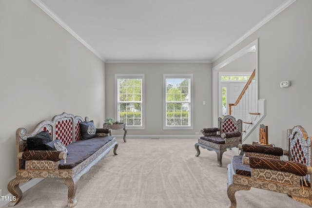 living area with stairway, carpet, baseboards, and crown molding