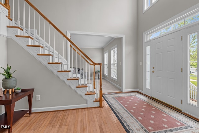 entryway with stairway, hardwood / wood-style floors, and a healthy amount of sunlight