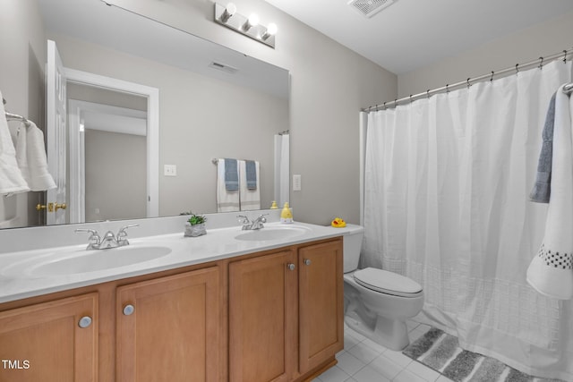 bathroom with a sink, visible vents, and tile patterned floors