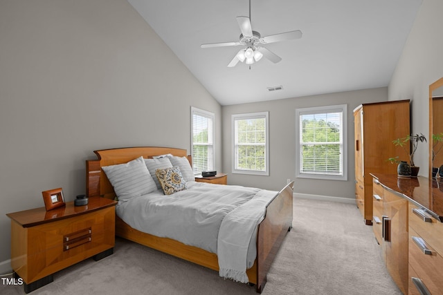 bedroom featuring light carpet, vaulted ceiling, multiple windows, and visible vents