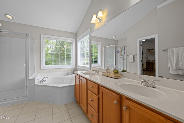 bathroom featuring a stall shower, double vanity, a sink, and lofted ceiling