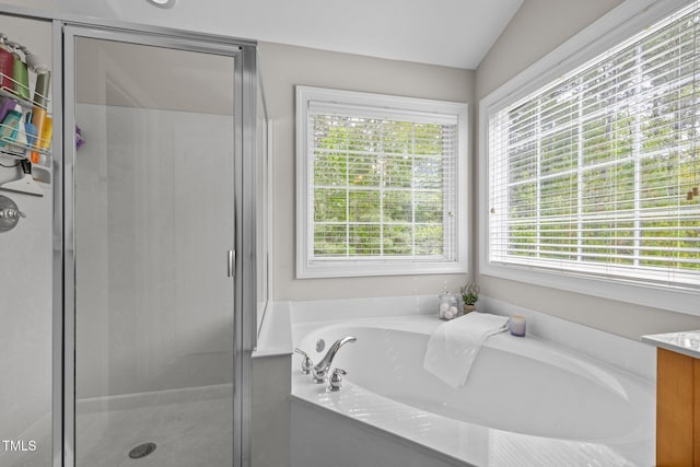 bathroom featuring a shower stall, vanity, and a bath