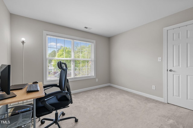 office space featuring baseboards, carpet, and visible vents