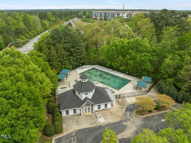birds eye view of property with a view of trees