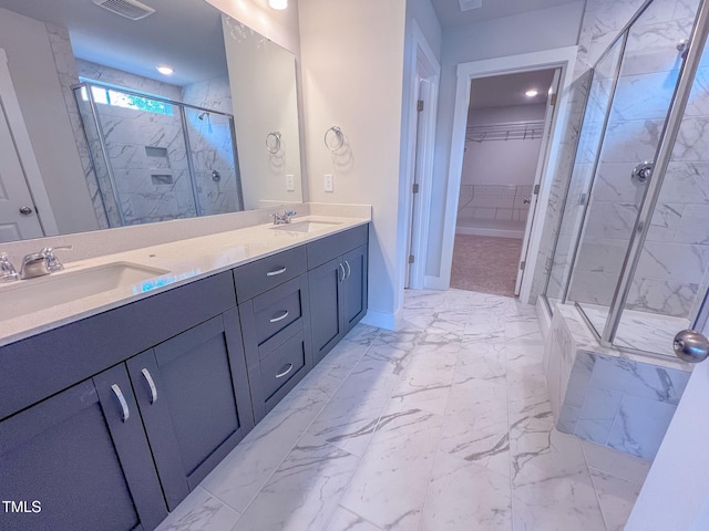 217 Duncan Creek Rd # 124, Lillington, NC 27546 - bathroom featuring marble look tile flooring, a marble finish shower, double vanity, a spacious closet, and baseboards