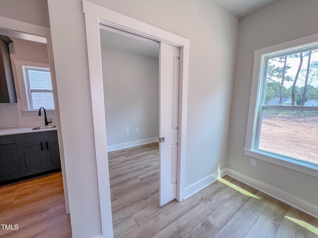 217 Duncan Creek Rd # 124, Lillington, NC 27546 - hall featuring a sink, light wood-style flooring, and baseboards
