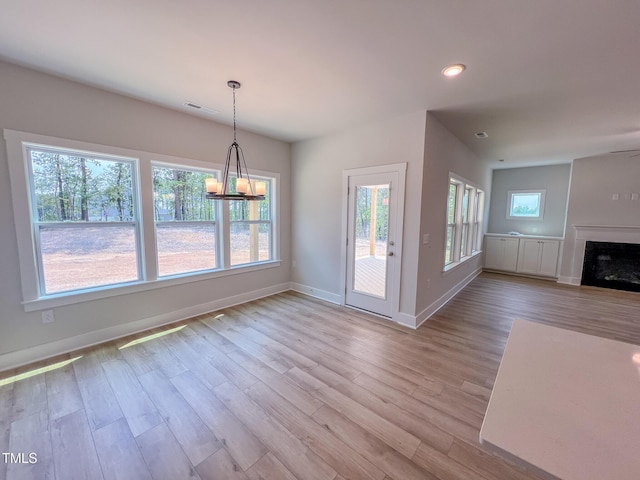 217 Duncan Creek Rd # 124, Lillington, NC 27546 - unfurnished dining area featuring baseboards, wood finished floors, a fireplace, and recessed lighting