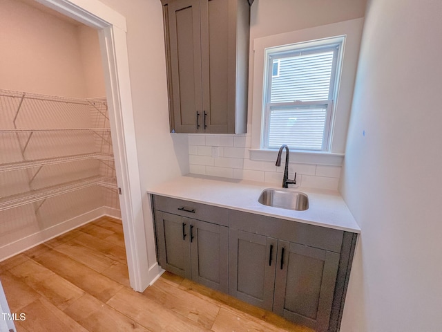 217 Duncan Creek Rd # 124, Lillington, NC 27546 - bar area featuring a sink, tasteful backsplash, and light wood-style floors